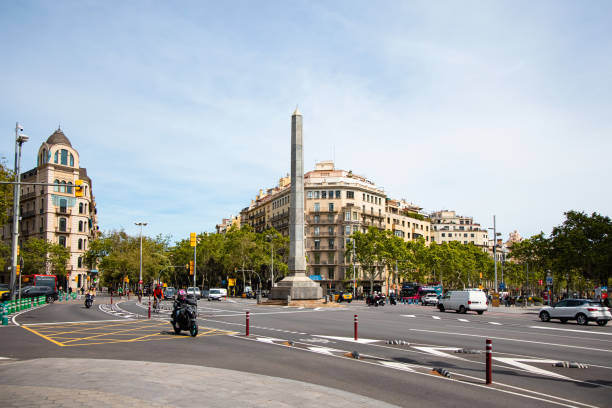 Madrid, Spain. \nView from inside a vehicle of pedestrians crossing a crosswalk next to Parque del Buen Retiro in Madrid on a sunny winter morning.