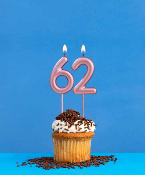 istock Birthday candle with cupcake on blue background - Number 62 2152210479