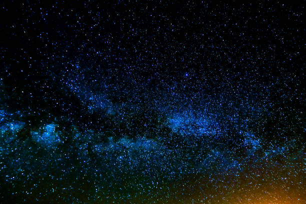 A dark sky with a bright blue starry sky. The stars are scattered throughout the sky, creating a sense of depth and vastness. The blue color of the sky contrasts with the darkness of the night