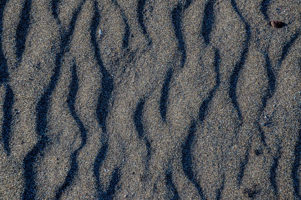 istock A close up of a sandy beach with a black and white pattern 2152213450