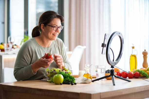 istock Woman using mobile phone for streaming online healthy eating masterclass lesson 2152213592