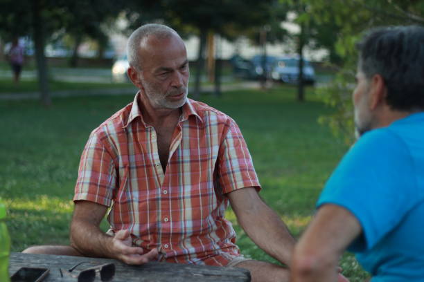 istock Two mature men old friends talking 2152213987