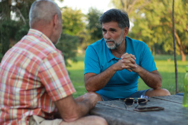 istock Two mature men old friends talking 2152213988