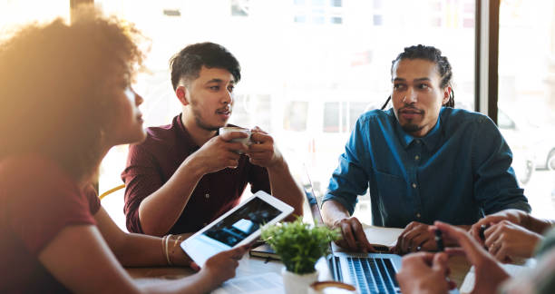 istock People, university student and study group with tech at cafe on campus to talk exams, test and assignment. College learner, teamwork and collaboration with studies, progress and project ideas 2152223883
