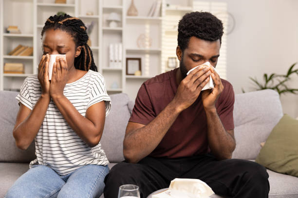 istock Couple Sick With Cold, Blowing Noses Together At Home 2152225225