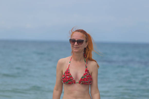 Woman in swimwear enjoy in shallow sea  on sunny summer day