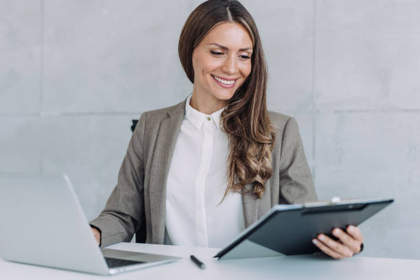 istock Confident businesswoman working on laptop and taking notes. 2152226571
