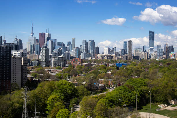 The downtown skyline of condos and office towers in Toronto, as seen from Broadview Ave, looking out across Riverdale park.