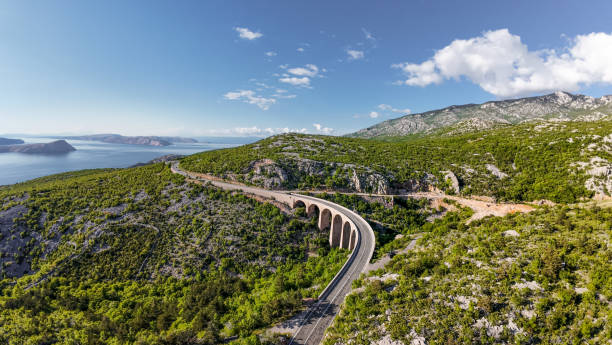 istock Ocean highway running through the mountain range with stone arch viaduct, beautiful shot 2152227711