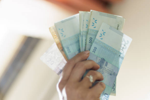 istock Hand holding Moroccan banknotes, dirham official currency of Morocco 2152231623