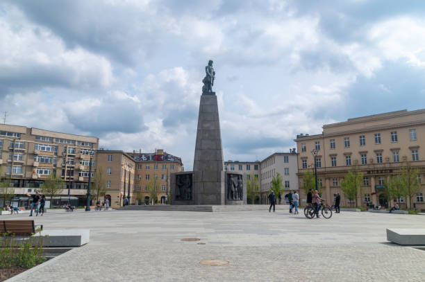 St. Mary's Basilica and detail of the Adam Mickiewicz Monument (designed by Teodor Rygier and built in 1898) on Main Market Square in Krakow, Poland.