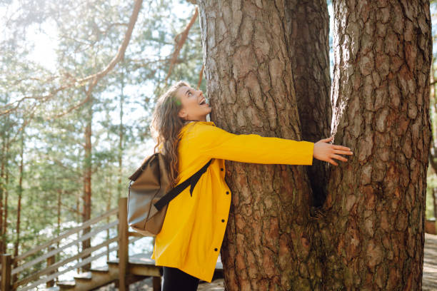 istock Woman with backpack hiking in autumn forest. 2152233744
