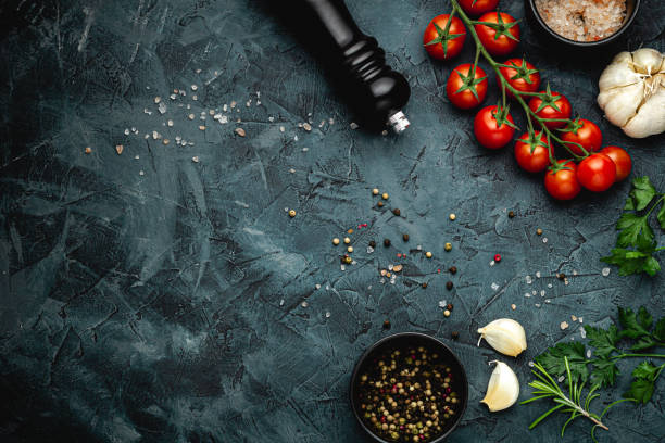 istock Dark stone kitchen background with spices, herbs and kitchen utensils. Free space for text. Top view. Rustic style. 2152234592