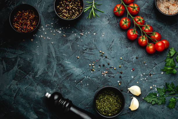 istock Dark stone kitchen background with spices, herbs and kitchen utensils. Free space for text. Top view. Rustic style. 2152234596