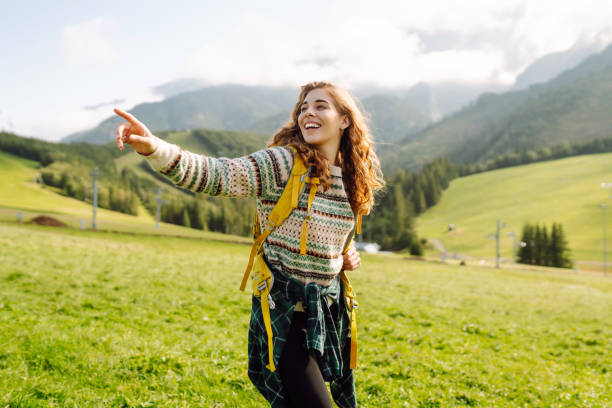 istock Hiker contemplating mountain views  in a green in a valley. 2152235111