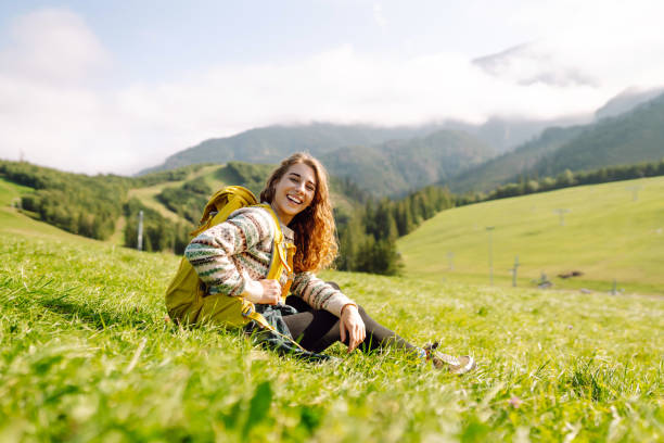 istock Hiker contemplating mountain views  in a green in a valley. 2152235112