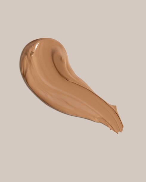 istock Makeup foundation, beige concealer swatch smudge smear on beige background. BB CC cream texture 2152235307