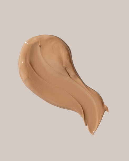 istock Makeup foundation, beige concealer swatch smudge smear on beige background. BB CC cream texture 2152235315