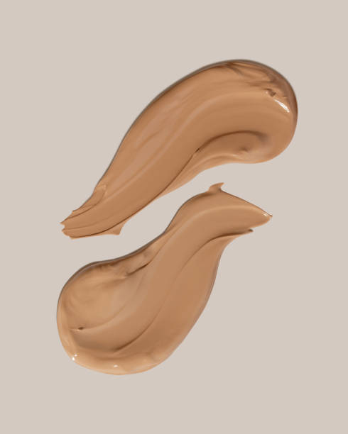 istock Makeup foundation, beige concealer swatch smudge smear on beige background. BB CC cream texture 2152235316