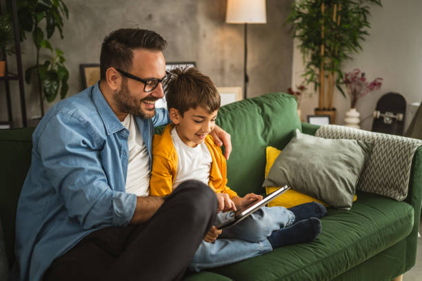 istock Father look son while he play video games or browse internet on tablet 2152239196