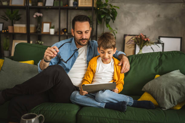 istock Father look son while he play video games or browse internet on tablet 2152239219