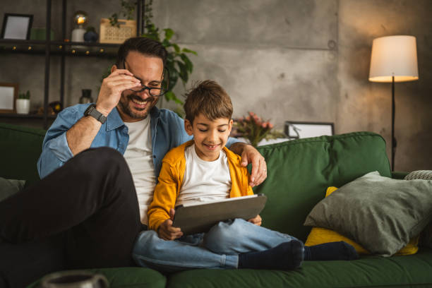 istock Father look son while he play video games or browse internet on tablet 2152239225
