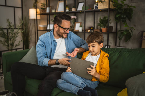 istock Father look son while he play video games or browse internet on tablet 2152239261