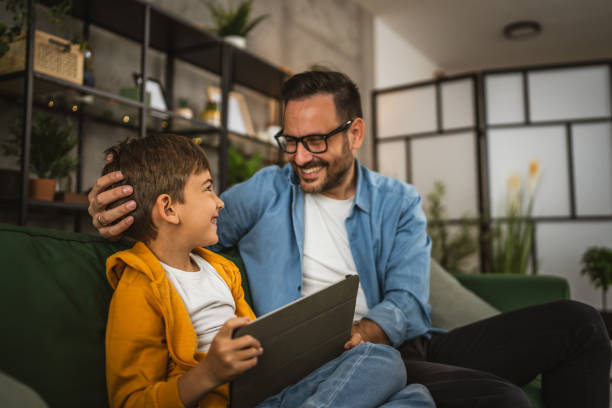 istock Father look son while he play video games or browse internet on tablet 2152239378