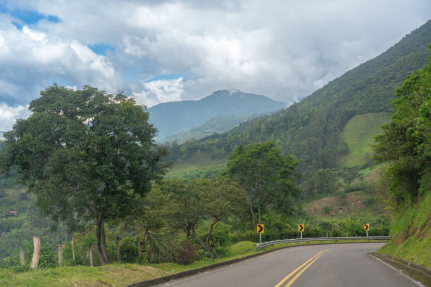 istock Colombian highway between a landscape with mountains and tropical trees. 2152239634
