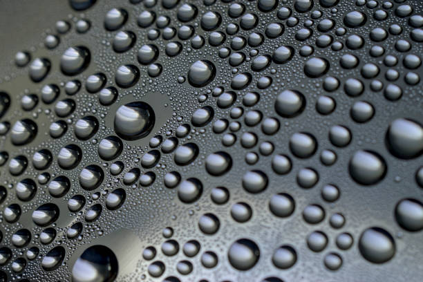 Macro view of raindrops on a transparent window. Rain droplet concept.