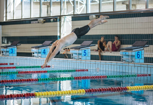 istock Swimmer jumping off the starting block 2152242167