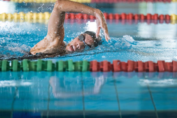istock Professional female swimmer swimming the front crawl stroke 2152242367