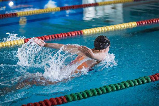 istock Female swimmer moving through the water performs a butterfly stroke 2152242408