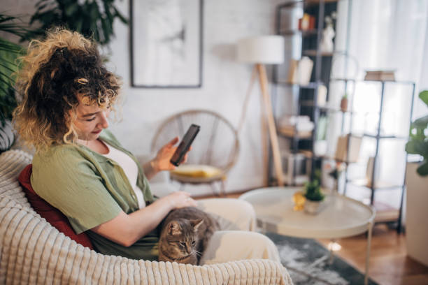 istock Young woman enjoying leisure time with cat at home 2152243071