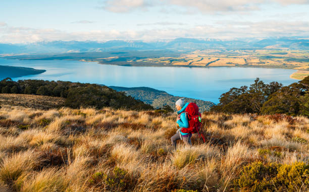 Young woman hiking with a view in background.