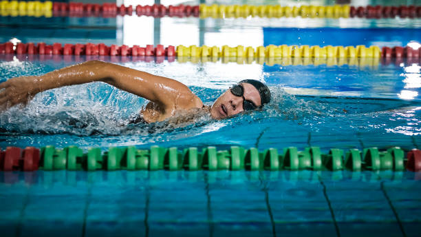 istock Professional female swimmer swimming the front crawl stroke 2152243348