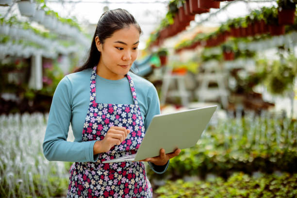 istock Asian Women Using Laptop at Her Greenhouse 2152244814