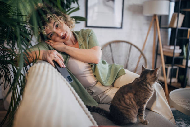 istock Woman relaxing at home with pet cat 2152244884