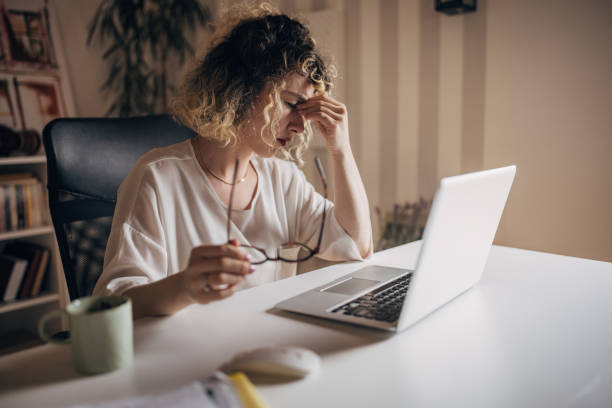 istock Stressed woman working late on laptop in home office 2152245006