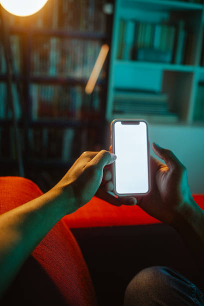 istock Holding smart phone with blank screen at home 2152245207
