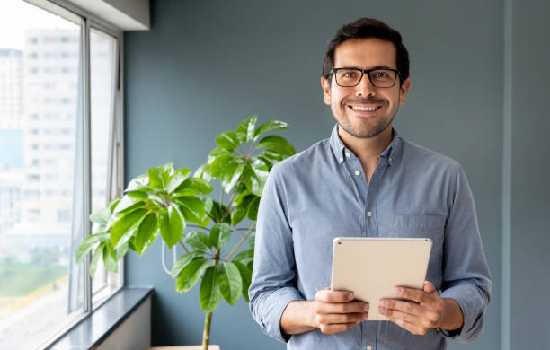 istock Happy businessman working at the office using a digital tablet 2152247377
