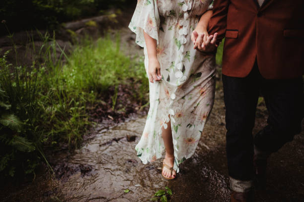 Follow me to concept, young man leading girlfriend to forest path