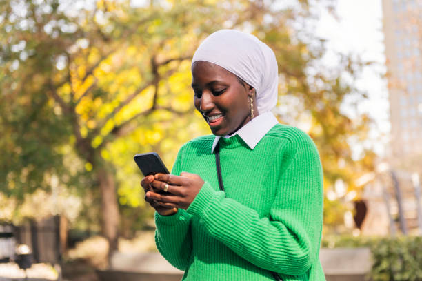 istock black woman smiling happy using her mobile phone 2152254694