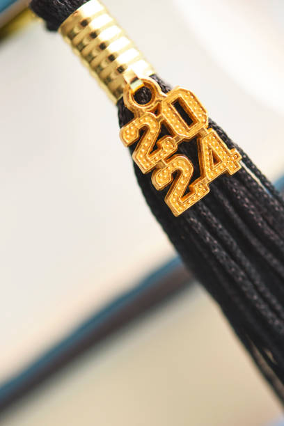 2024 graduation tassel with a stack of books and space for text