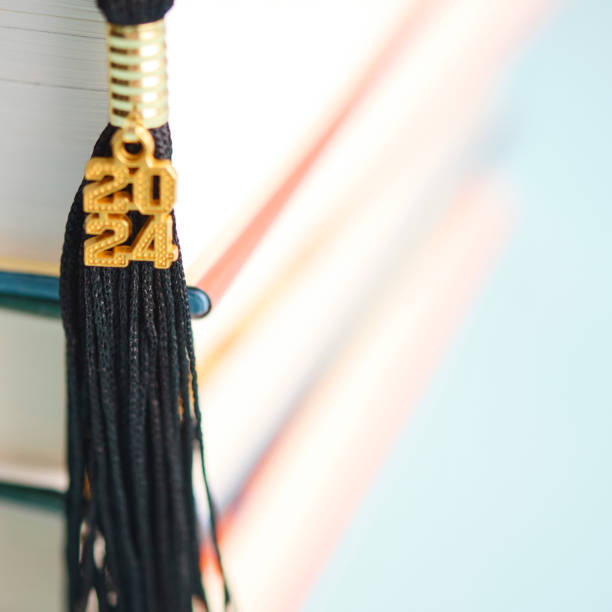2024 graduation tassel with a stack of books and space for text