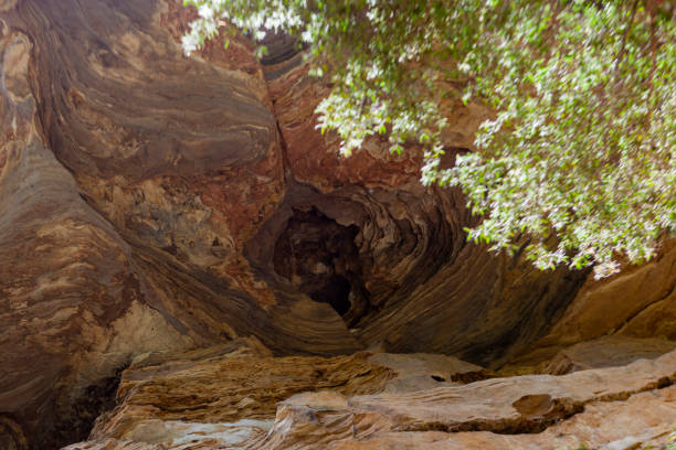 Young Caucasian woman stnding  in the  cave, Thailand 