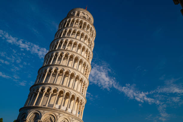 A breathtaking view of Italy's pisa famous Leaning Tower under a blue sky, highlighting its grandeur and beauty