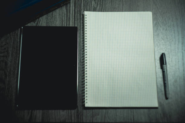 Workplace. Notebook with black marker and coffee mug on wooden table. High quality photo