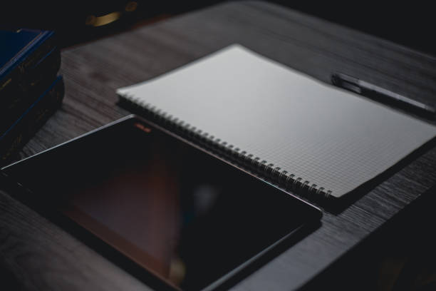 Workplace. Notebook with black marker and coffee mug on wooden table. High quality photo