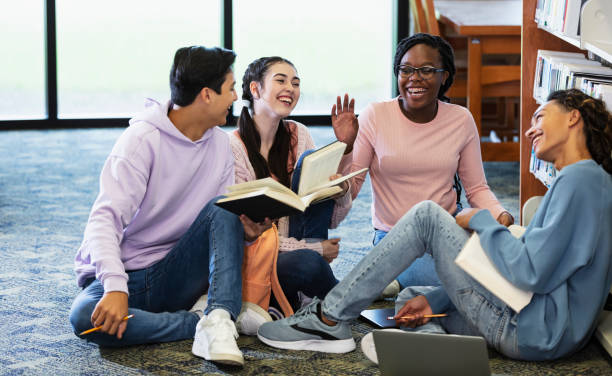 istock Four high school students studying together in library 2152265354